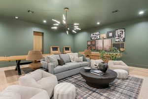 Living room featuring wood finished floors and a chandelier