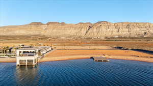 Dock area featuring a water and mountain view