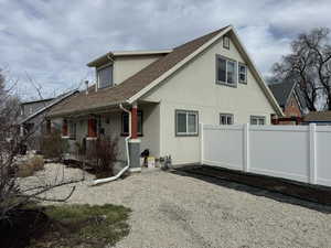 Front and Side of property featuring stucco siding and roof with shingles