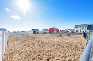 View of yard featuring an outbuilding, a residential view, and an exterior structure