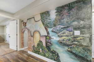 Corridor with hardwood / wood-style flooring and baseboards