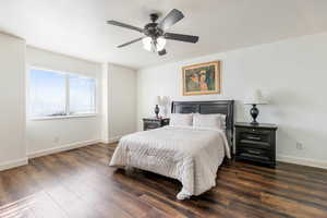 Bedroom featuring dark wood-type flooring and a ceiling fan
