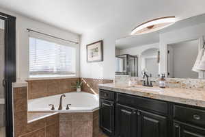 Full bathroom with vanity, a garden tub, and a stall shower