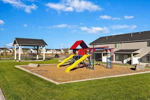 Community jungle gym with a residential view, a yard, and a patio