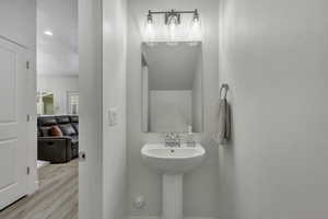 Bathroom featuring wood finished floors and recessed lighting