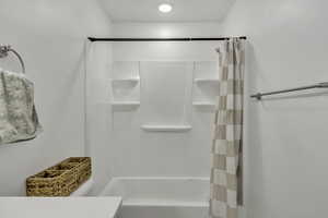 Bathroom featuring vanity and shower / tub combo