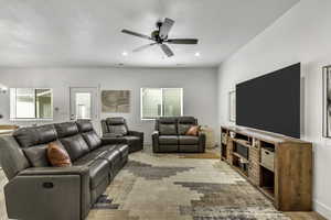 Living room with ceiling fan and recessed lighting