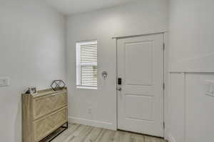 Entryway featuring light wood-type flooring and baseboards