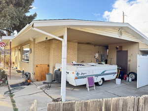 View of parking featuring an attached carport