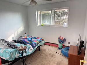 Bedroom featuring ceiling fan and carpet floors