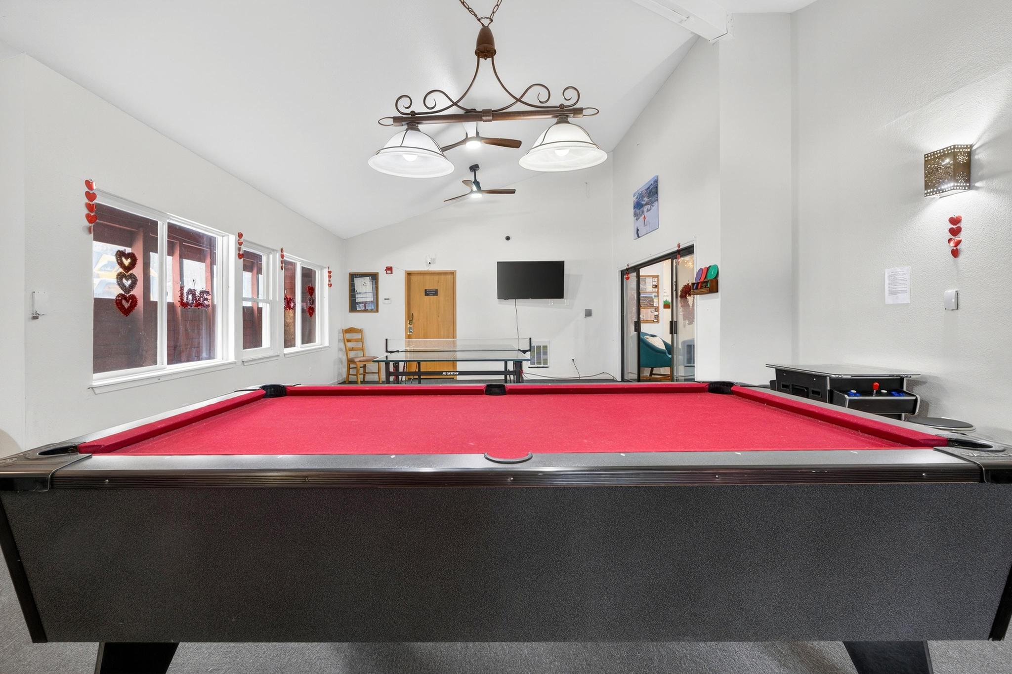 Recreation room featuring ceiling fan, vaulted ceiling, and pool table