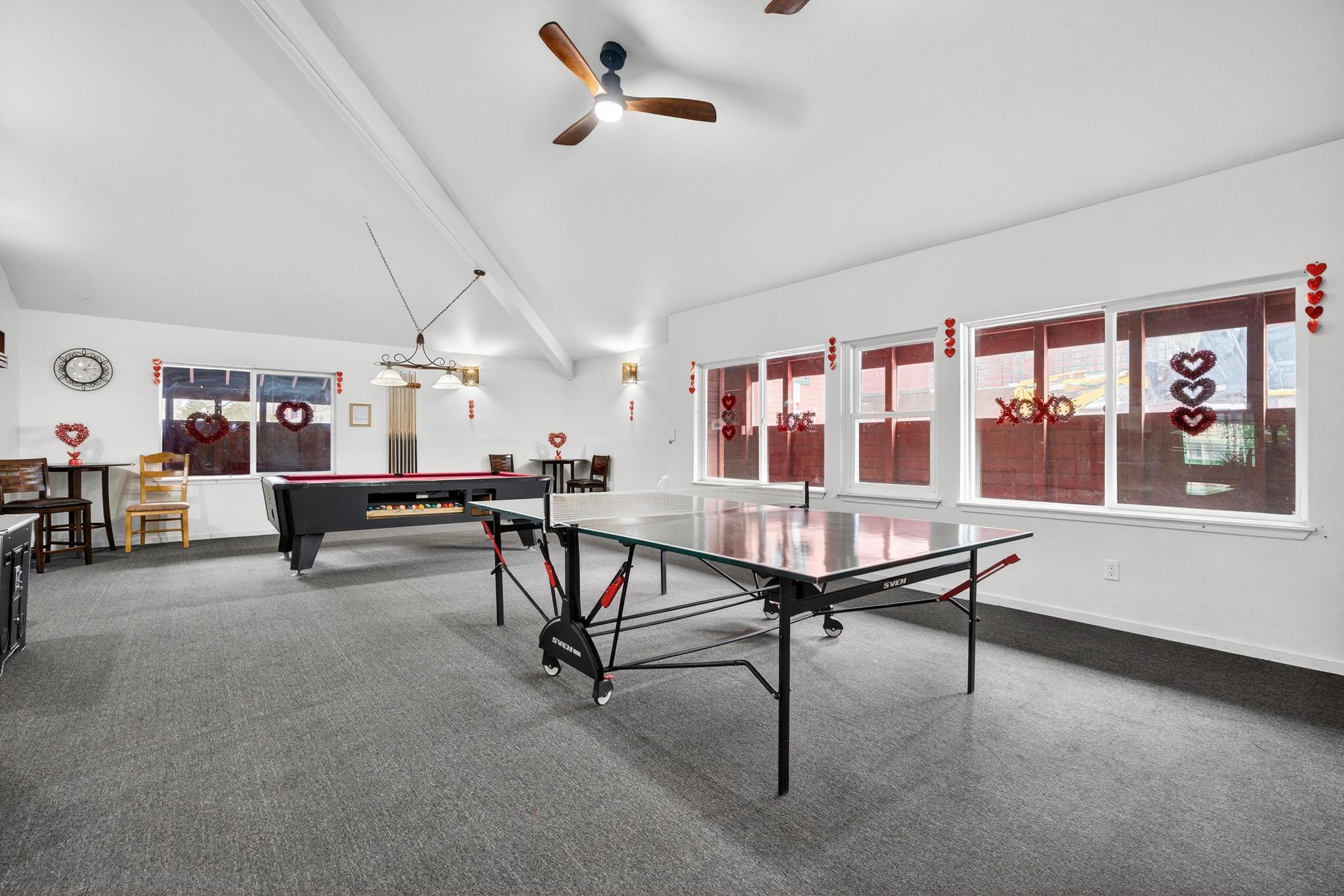Recreation room with billiards table, lofted ceiling with beams, and a ceiling fan