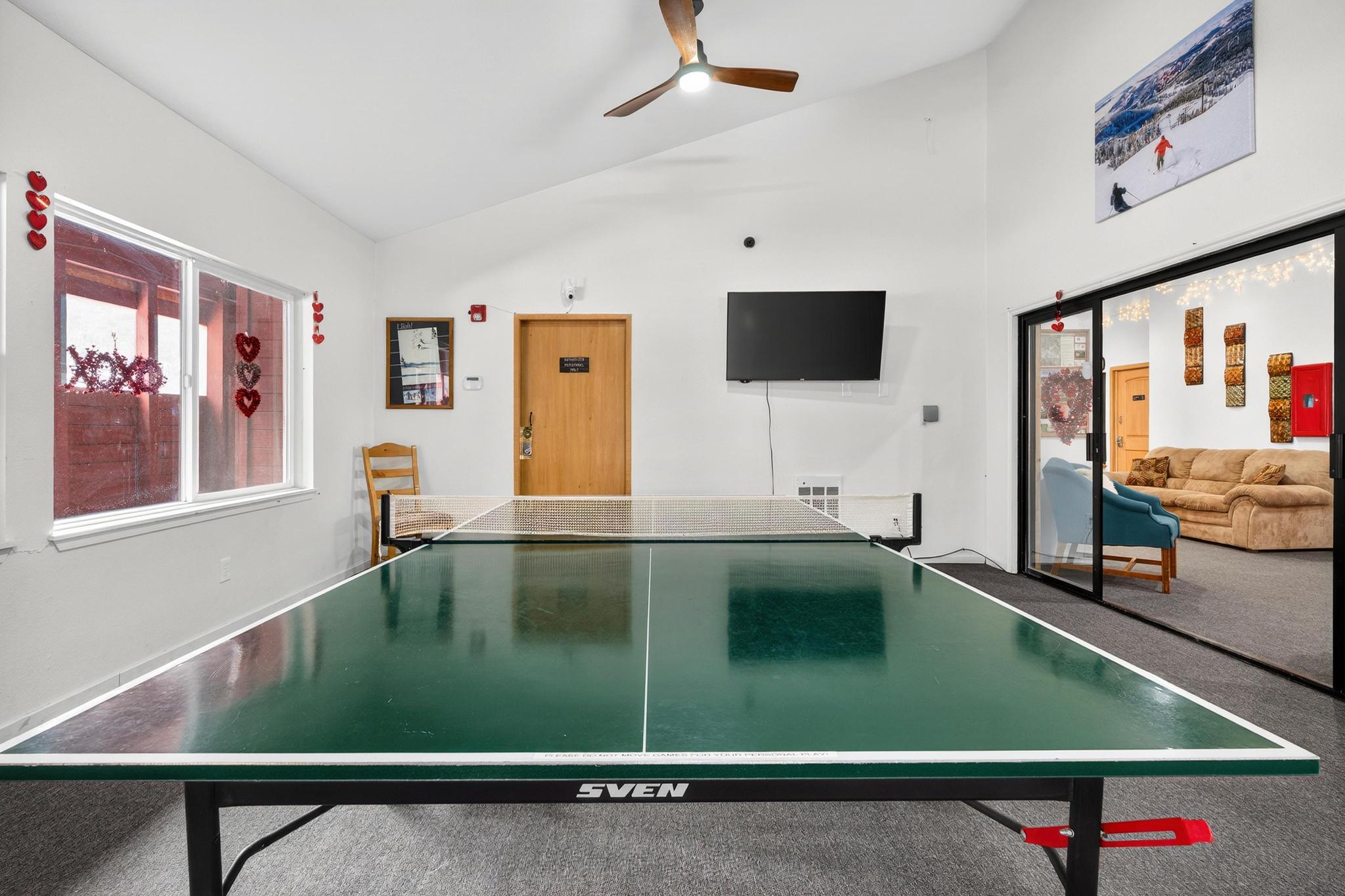 Recreation room featuring ceiling fan and lofted ceiling