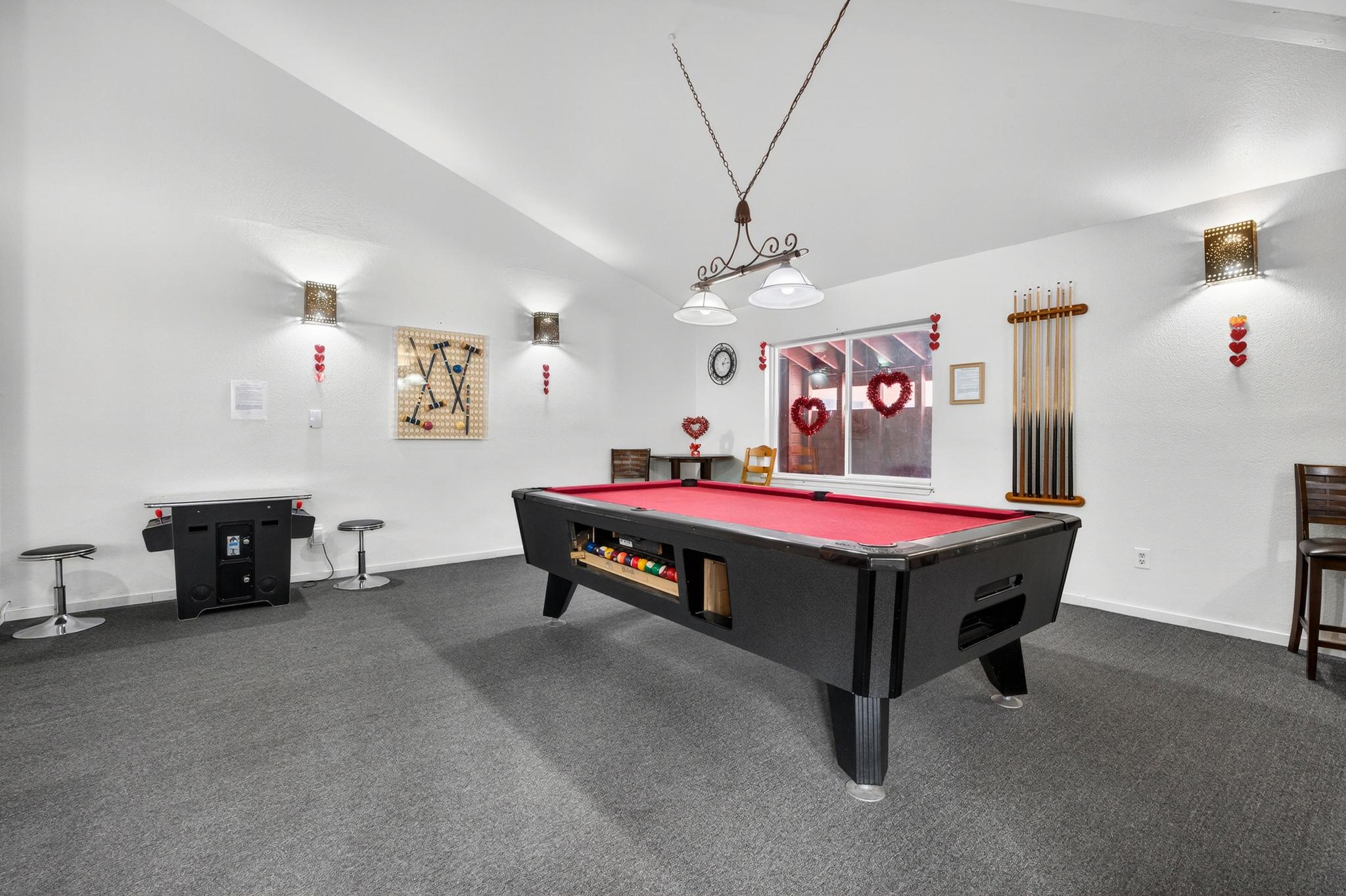 Recreation room featuring dark colored carpet, pool table, and lofted ceiling