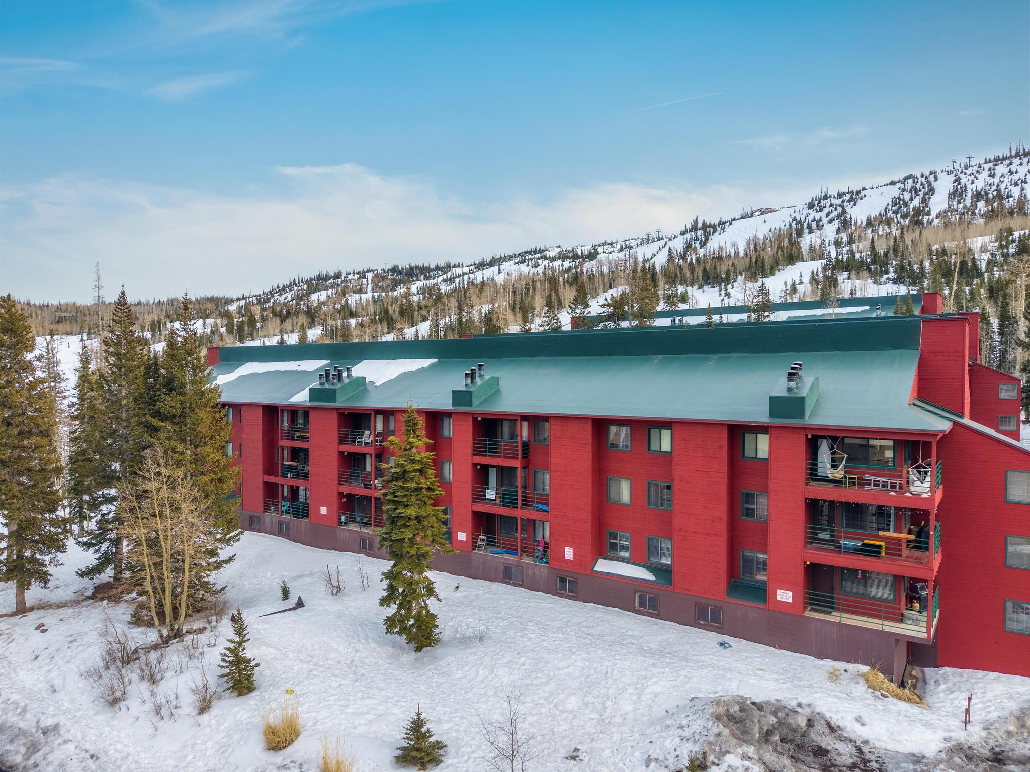 Snow covered building with a view of apartment building / complex