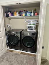 Laundry area featuring carpet flooring and washer and dryer