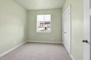 Secondary Bedroom  with light carpet and baseboards