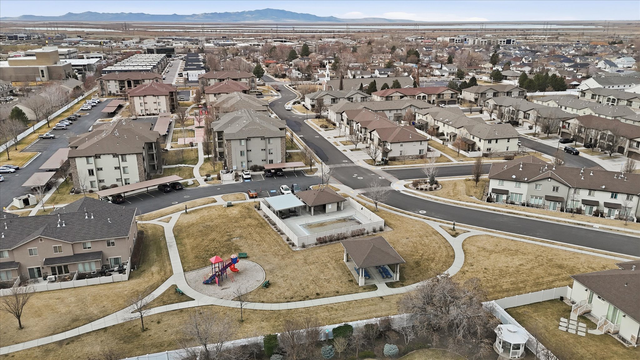 Aerial overview of property's location featuring nearby suburban area and mountains