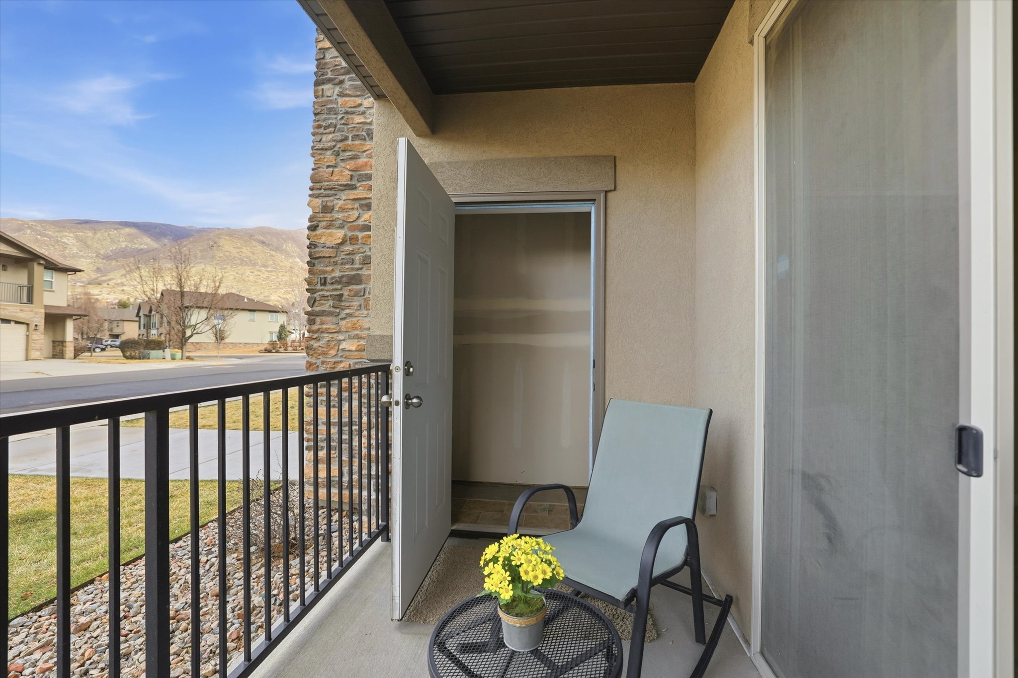 Front covered patio with mountain views and a storage room.