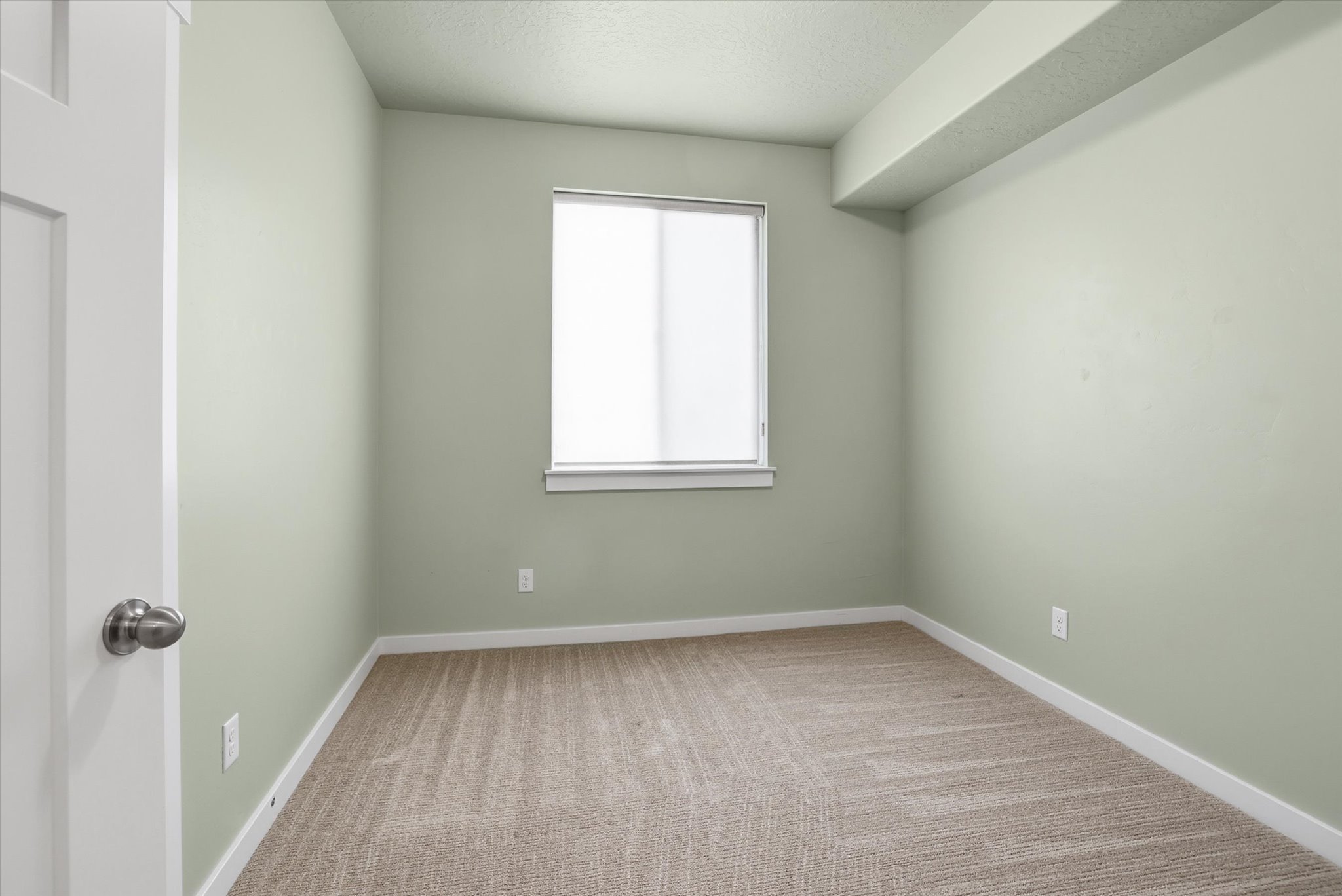 Secondary bedroom  with baseboards and a textured ceiling
