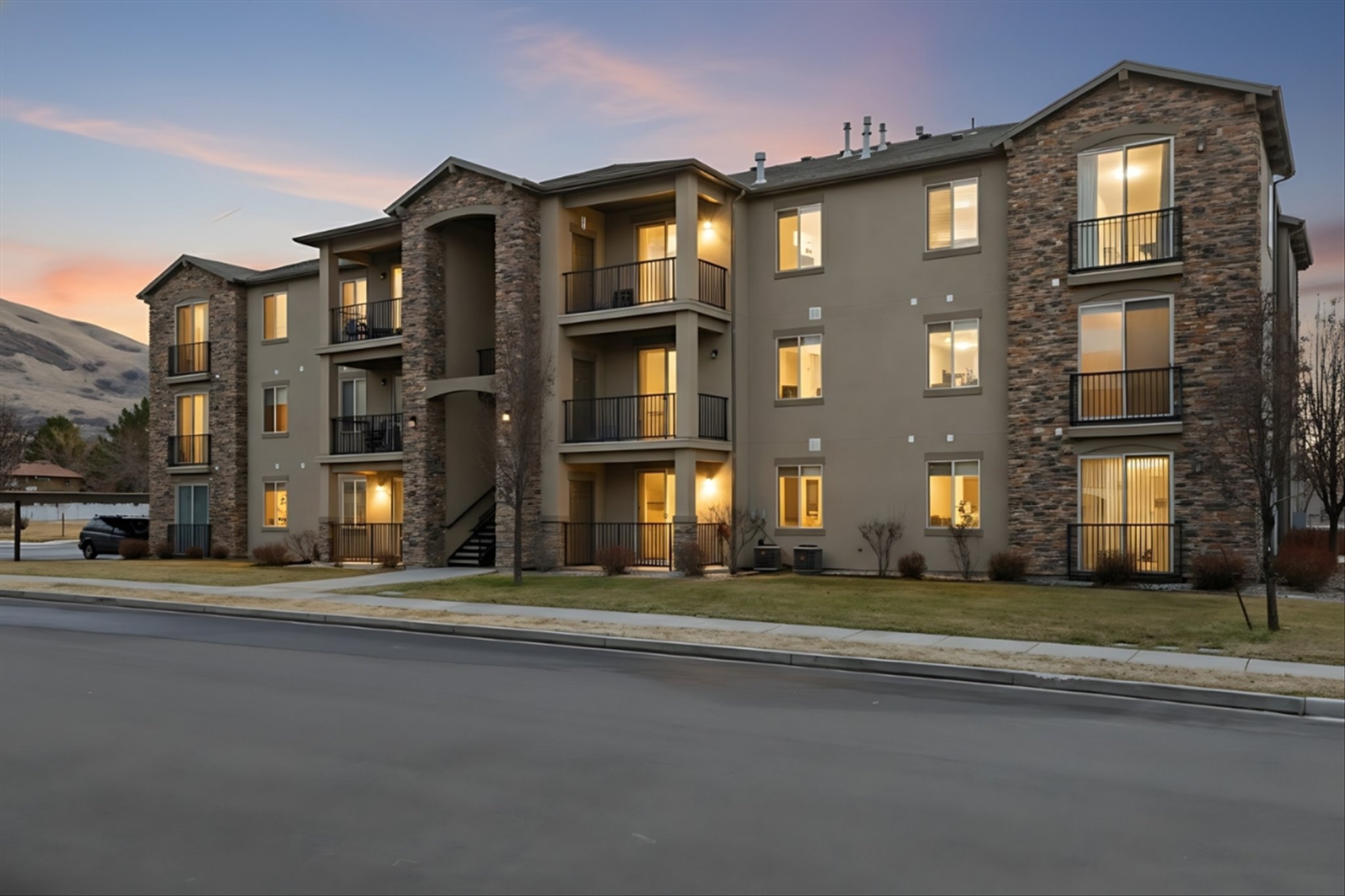 Property at dusk featuring a view of condominium building / complex