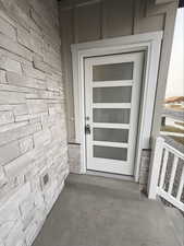 Entrance to property with stone siding
