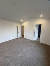 Unfurnished bedroom featuring carpet, recessed lighting, and lofted ceiling