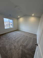 Carpeted spare room with lofted ceiling and recessed lighting