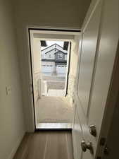 Doorway to outside featuring wood finished floors and baseboards