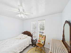 Bedroom with carpet and a ceiling fan
