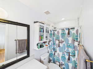 Full bathroom with curtained shower and vanity