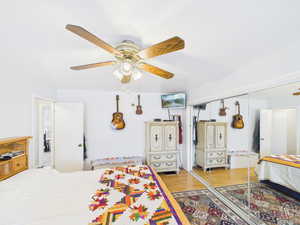 Bedroom with light wood-style flooring, a ceiling fan, and a closet