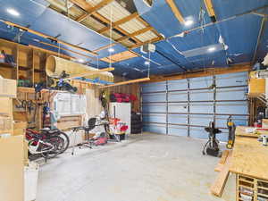 Detached Garage featuring a workshop area and a garage door opener