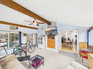 Living room with ceiling fan, carpet, lofted ceiling, and french doors