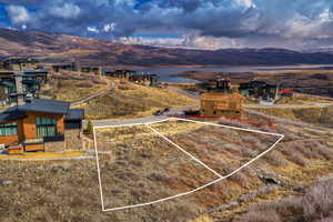 Aerial view of property's location with property boundaries highlighted and a water and mountain view
