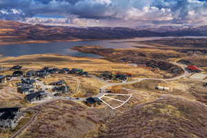 View of property location with a water and mountain view and nearby suburban area