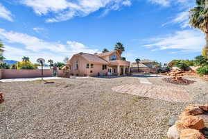 Rear view of property with a patio area, a fenced backyard, a tiled roof, and stucco siding