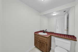 Half bath featuring toilet and vanity