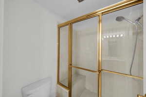 Bathroom with a stall shower and toilet