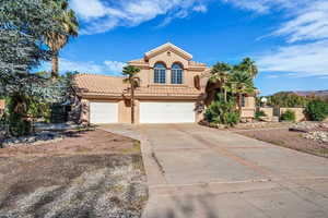 Mediterranean / spanish-style home featuring stucco siding, concrete driveway, a tile roof, and a garage