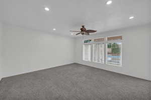 Empty room with a ceiling fan, carpet, crown molding, and recessed lighting