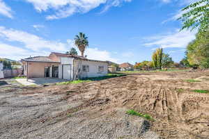 Rear view of property with a patio area and a garage