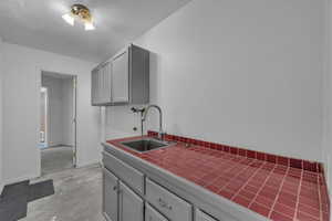 Laundry room with concrete flooring and a textured ceiling