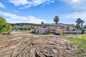 View of yard with a mountain view and a storage shed