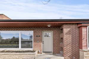 Entrance to property with brick siding