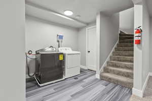 Laundry area featuring washing machine and dryer and light wood finished floors