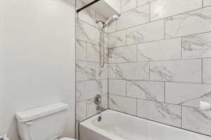 Full bathroom featuring shower / tub combination and toilet