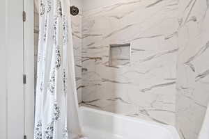 Full bathroom featuring shower / tub combo with curtain