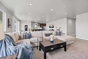 Living area featuring recessed lighting and light colored carpet