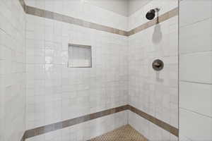 Bathroom featuring a tile shower